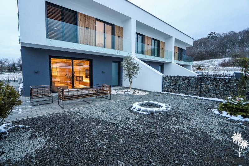 The exterior of a family house on Modrovka Street, Modrovka, with stone pathways and a terrace.