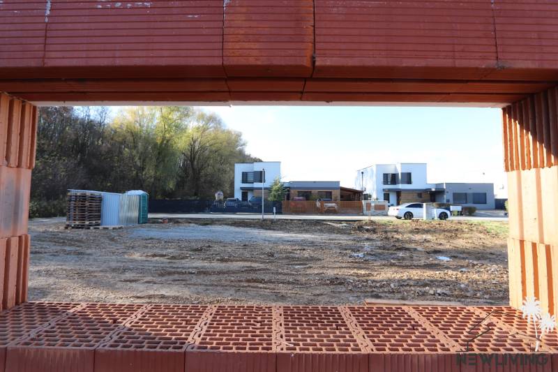 Construction of a family house on Drieňová Street in Nitra, view through the bricks to the surrounding houses.