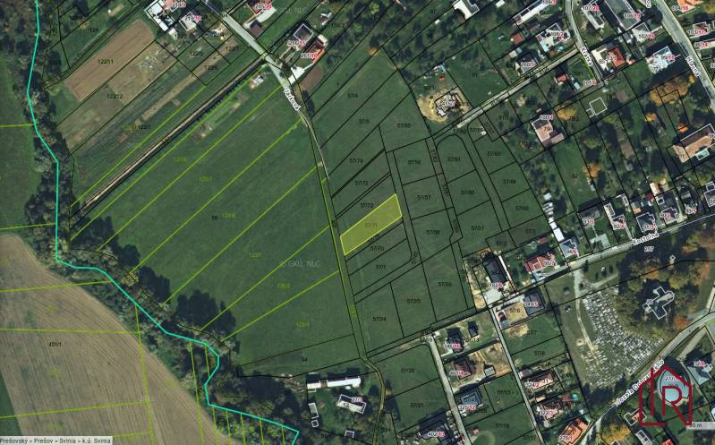 Aerial view of plots in the village of Svinia designated for housing, with marked parcels.