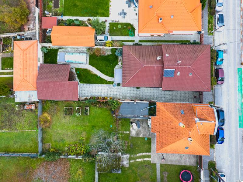 A top view of family houses on Školská Street in Senec with yards and gardens.