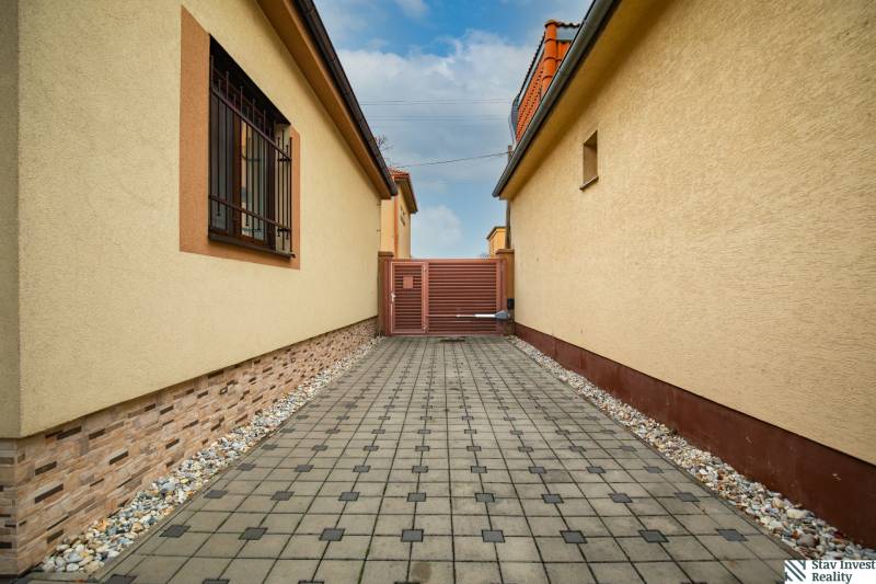 Paved sidewalk between family houses on Školská Street in Senec.