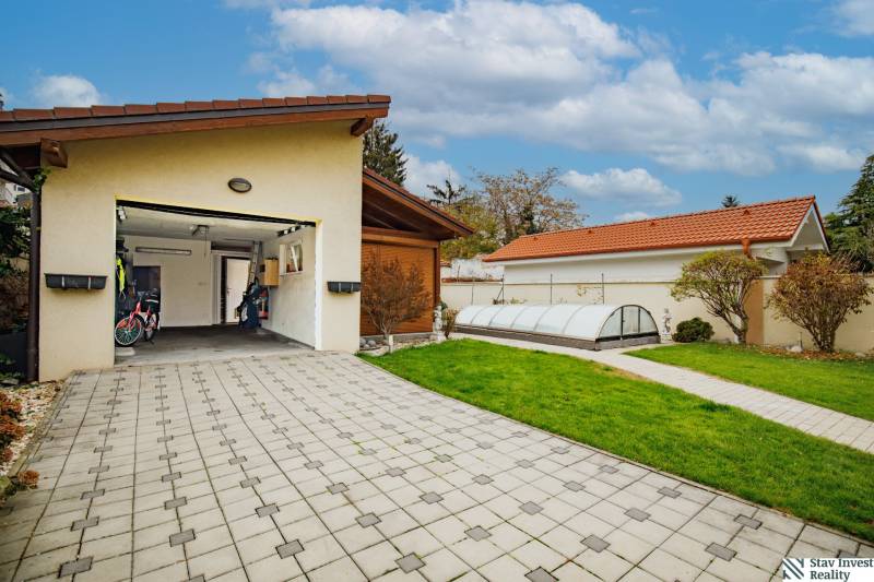 Family house on Školská Street in Senec with a garage, paving, and a garden.