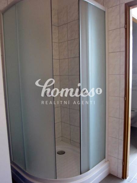 The image shows a shower enclosure with curved doors, on Štúrova Street.