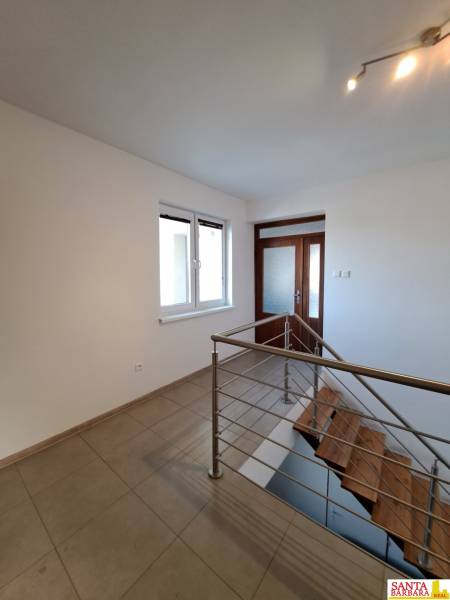 A hallway with ceramic tiles and a staircase in a 4-room apartment.