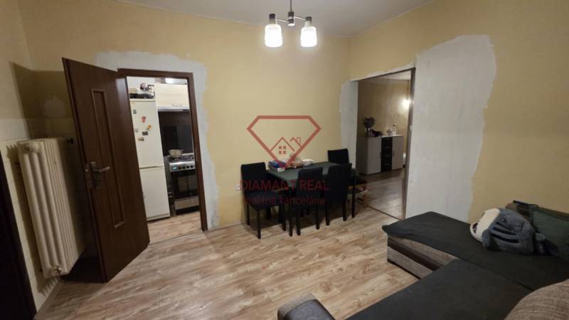 Living room in a family house with a wooden decor floor, table, and sofa.
