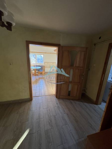 Interior of a family house with a wooden decor floor and a view into the room.