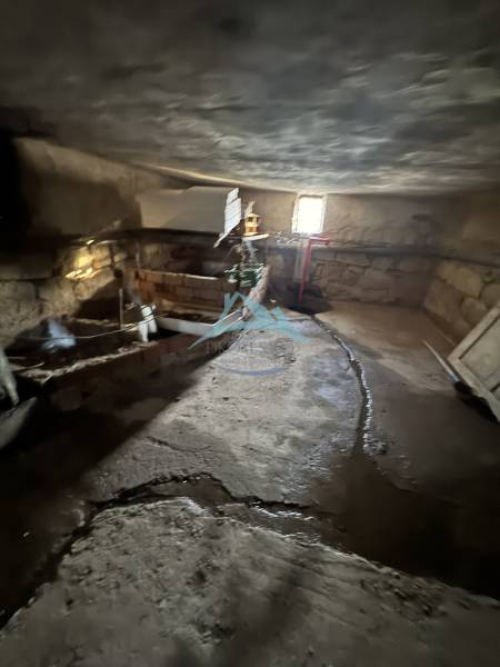 A cellar in a family house in Demandice with stone walls and simple lighting.