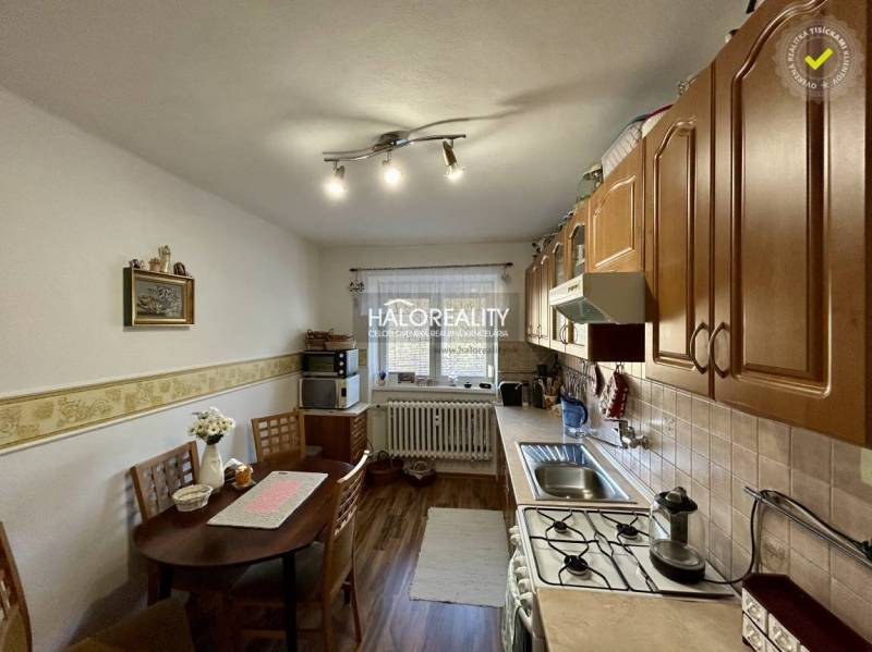 Kitchen with dining area, wooden decor flooring, 2-room apartment.