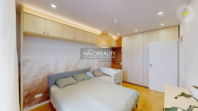 A bedroom in a 3-room apartment with built-in wardrobes, a bed, and a crib.