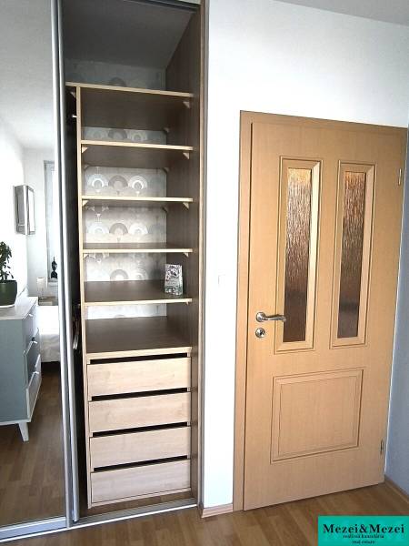 Built-in wardrobe with shelves and drawers, located in a 2-room apartment.