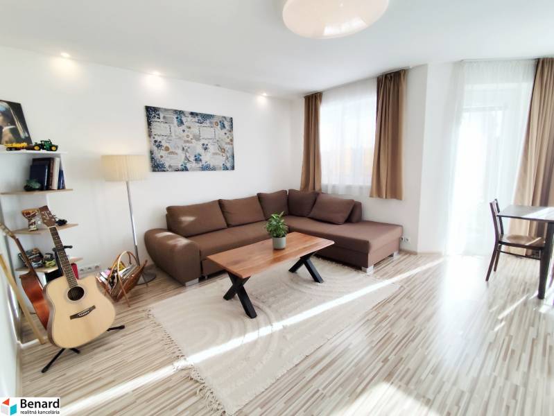 Living room in a family house with a large sofa and a floor with a wooden decor.