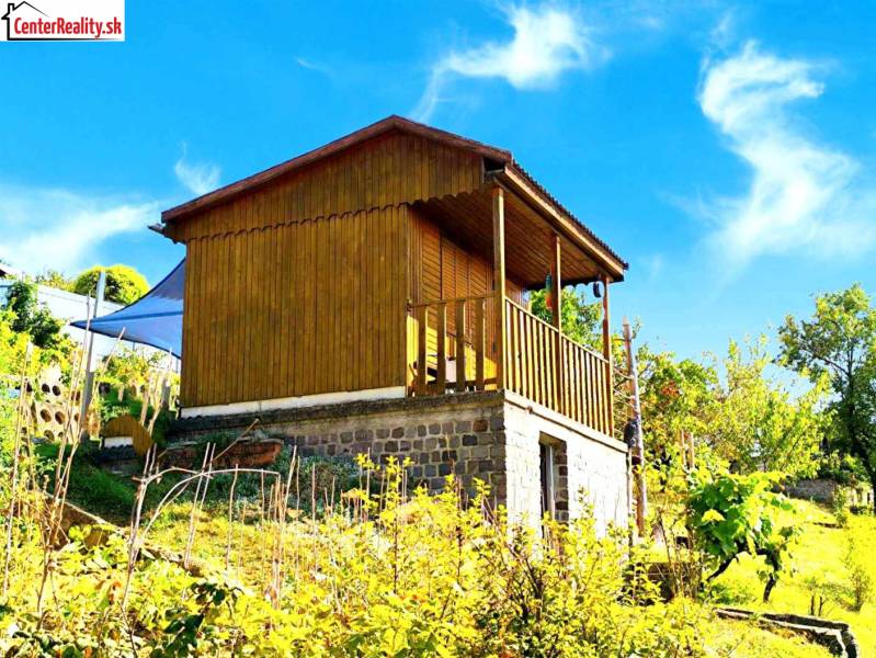 A wooden cabin surrounded by nature on a hillside, ideal for relaxation in a peaceful environment.
