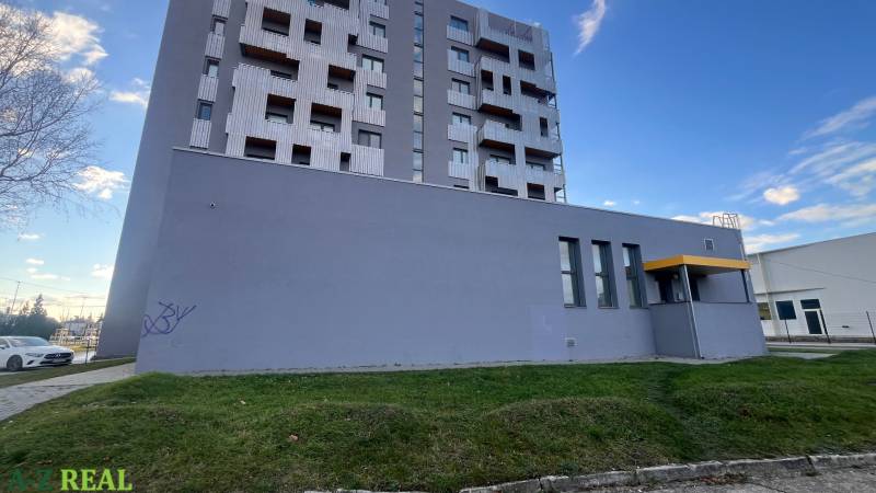 A building with balconies and a gray facade on Račianska Street in Bratislava-Rača.