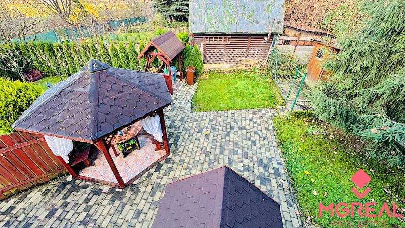 Garden gazebos near the Cottage in Partizánske are surrounded by greenery and paved walkways.
