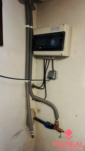 Electrical and plumbing installations in the cottage, including the cabinet and valves.