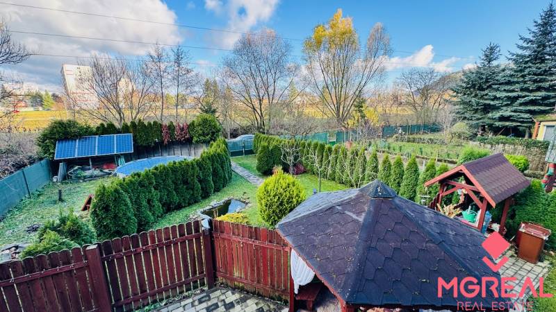 A garden at a cottage in Partizánske with a gazebo, solar panels, and a swimming pool.