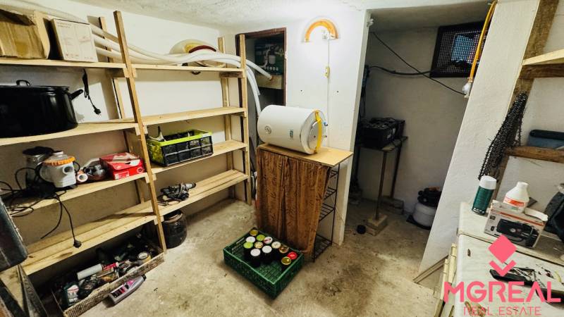 Storage space in a cabin with shelves and various tools and appliances.