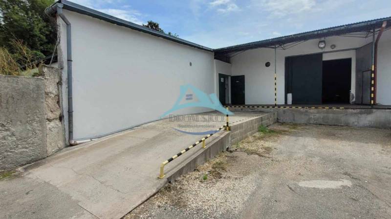 Warehouses and halls on Železničná Street with an access ramp and loading area.
