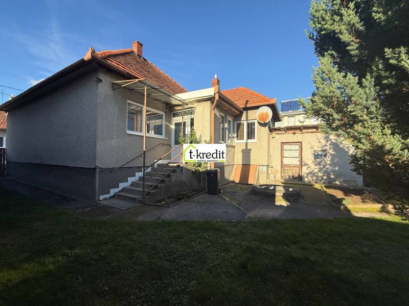 A family house in Machulince with a wooden roof and staircase on a built-up area.