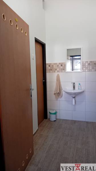 Offices with a sink, mirror, and floor with wood decor.