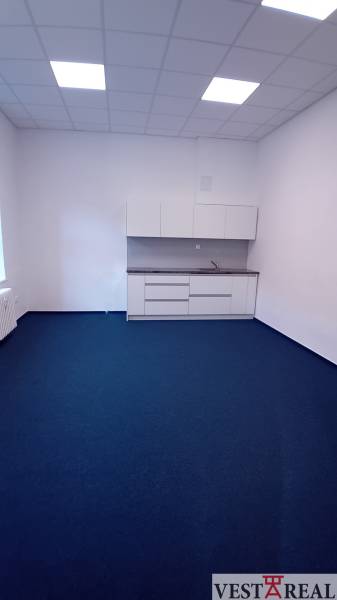 Offices with white cabinets and blue carpet on Františkánska Street in Trnava.