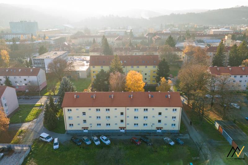 A view of apartment buildings on Tarasa Shevchenko Street in Prešov, surrounded by greenery.