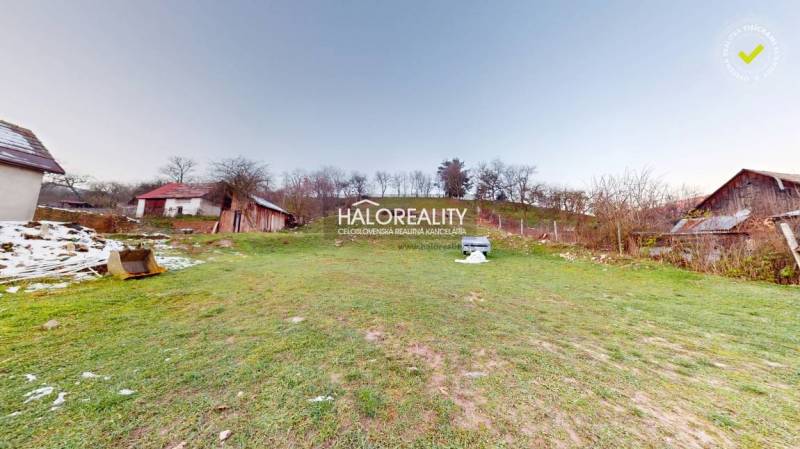 A spacious plot near a family house in Klenovec with a grassy area and smaller structures.
