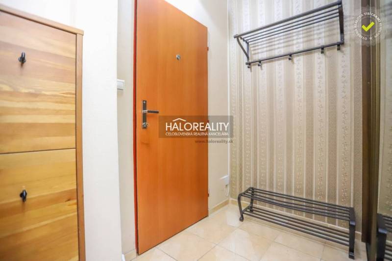 Entrance hallway of a 2-room apartment with a shoe cabinet and a wall-mounted coat rack.