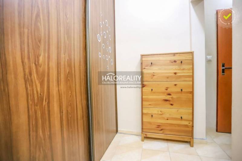 A hallway with a wardrobe and a chest of drawers in a 2-room apartment with tiles.
