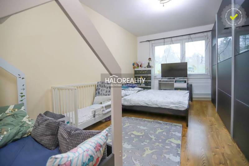 Children's room in a two-room apartment with a wooden decor floor and toys.