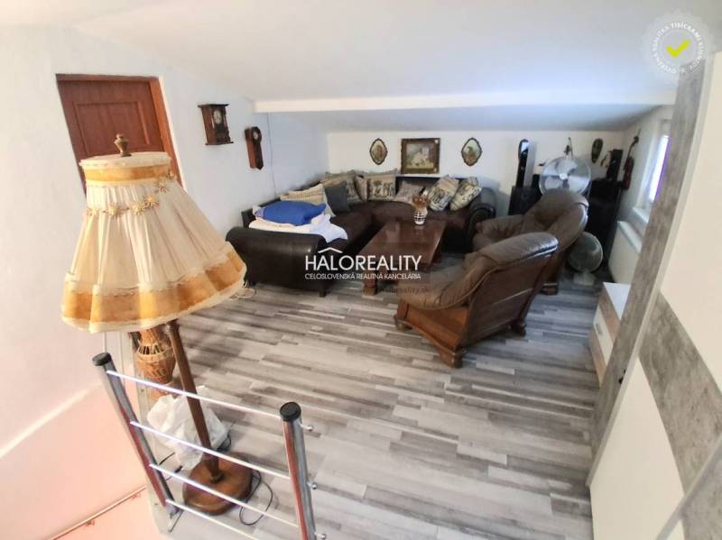 Living room with wooden decor and rustic furnishings in a family house.