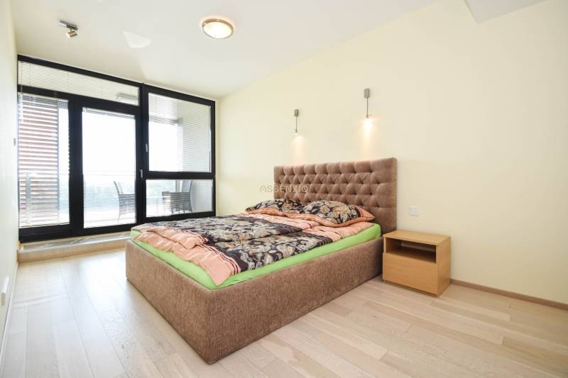 Bedroom in a 3-room apartment with a comfortable bed and a floor with a wooden decor.