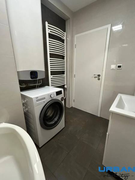 Bathroom in a 3-room apartment with a washing machine, sink, and radiator.