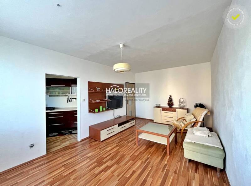 Living room with wood-patterned flooring in a 3-room apartment.