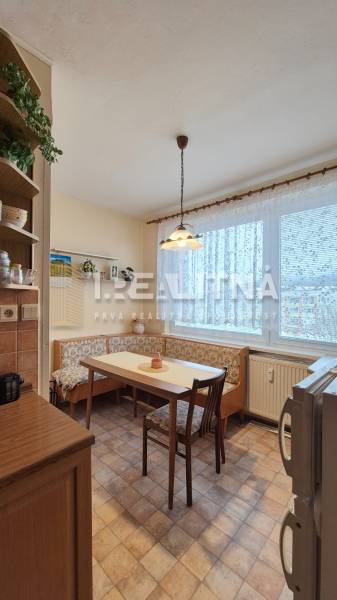 A kitchen corner with a corner bench in a 2-room apartment, floor with a wooden decor.