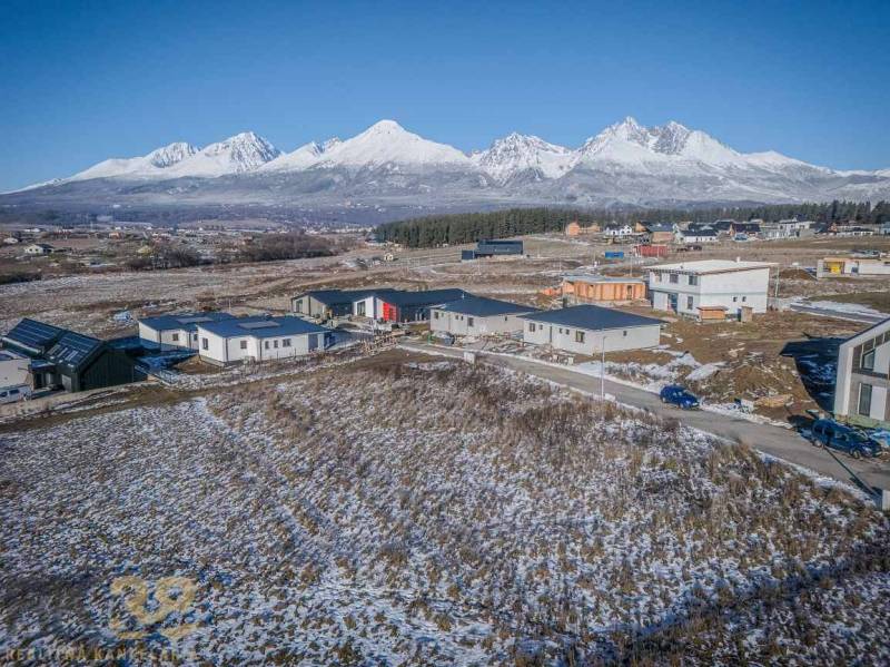 Snow-covered residential plots in Mlynica with panoramic mountain views.