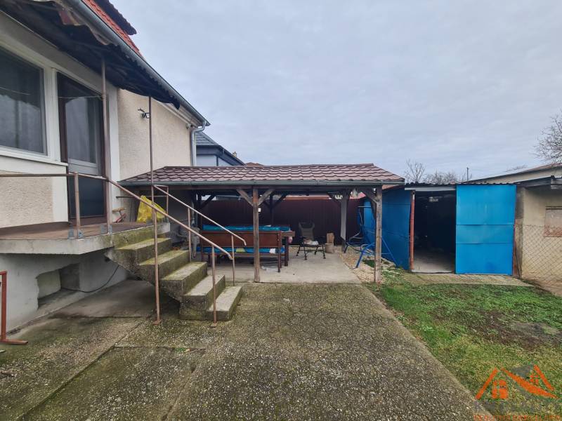 A family house in Hurbanovo with a spacious yard, a shelter, and external stairs.
