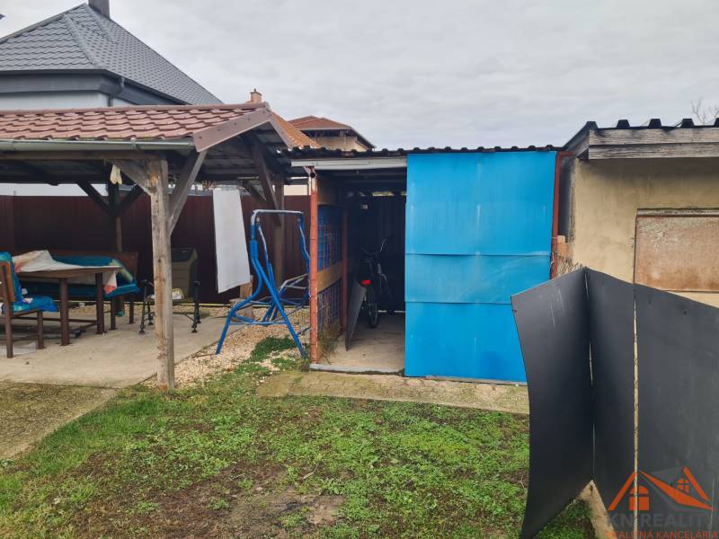 The garden of a family house in Hurbanovo, gazebo, shed, bicycle, swing, lawn area.