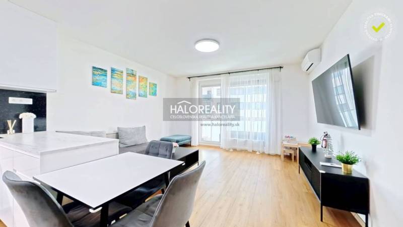 Living room in a two-room apartment with a wooden decor floor and furniture.