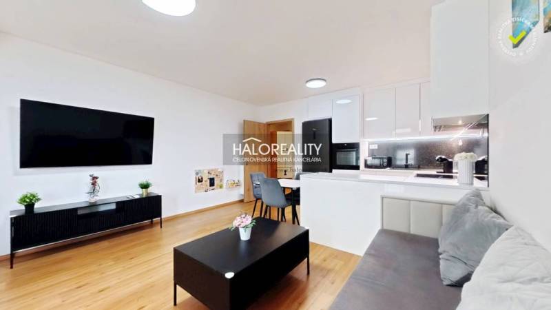 Living room in a two-room apartment, bright interior, kitchen unit, floor with wood decor.