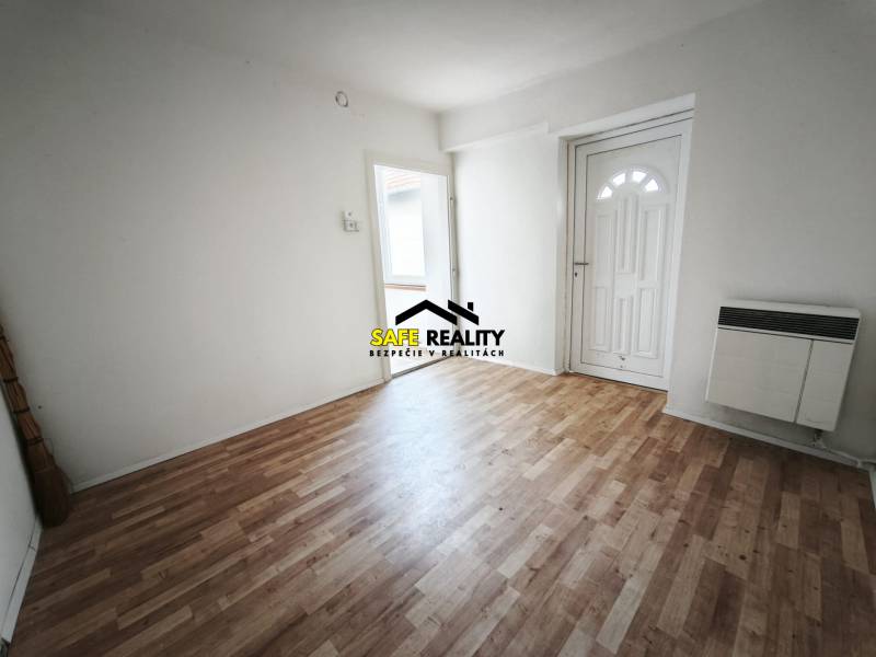 Interior of a family house with a wooden decor floor and white walls.