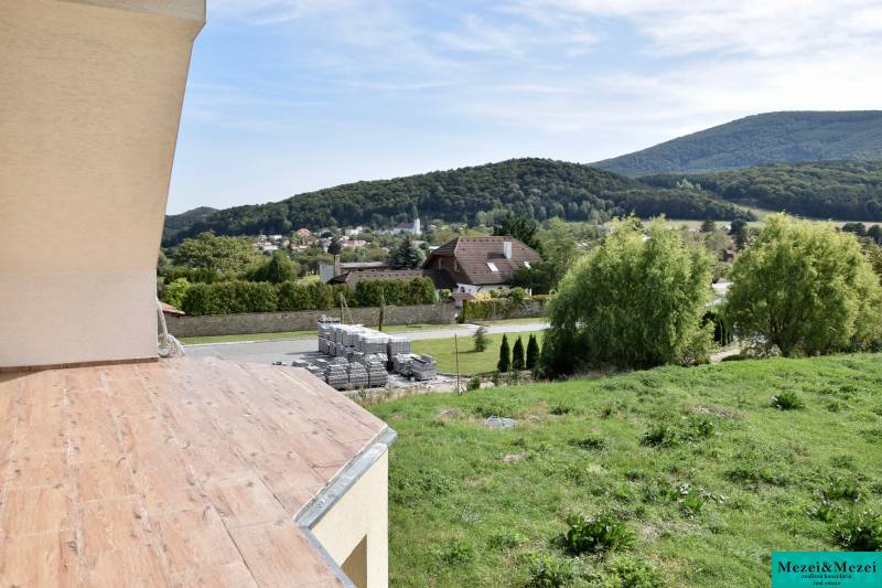 View from a family house in Buková to the hilly landscape, with a wooden decor floor.