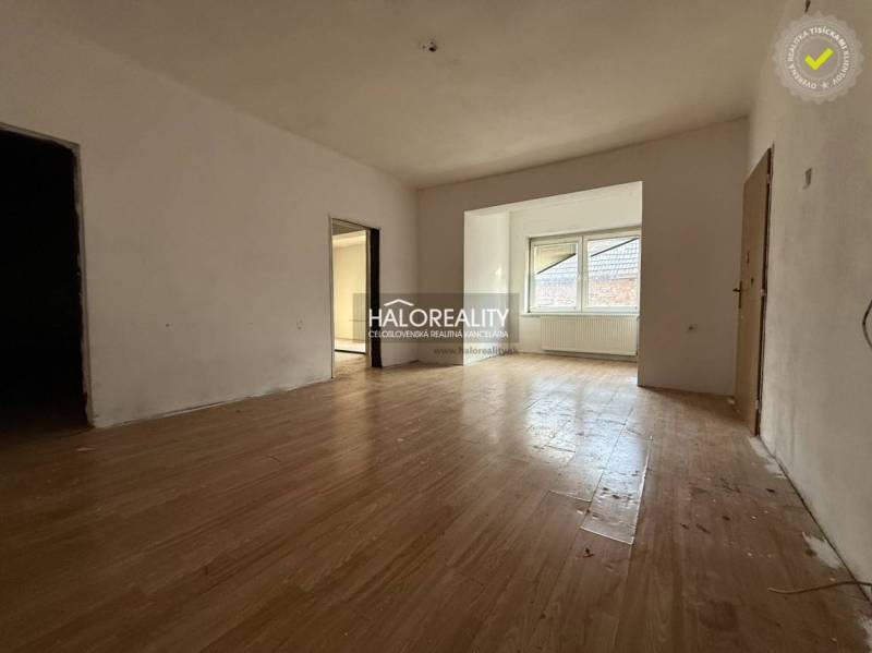 Interior of a family house with a wooden decor floor and a large window.