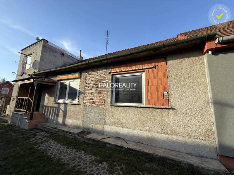 A family house in Chynorany with an unfinished facade, covered with a classic tile roof.