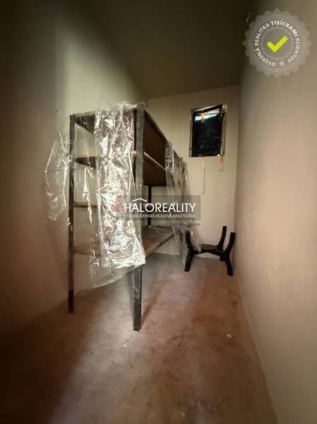 Narrow storage room with shelves and plastic wrap in a family house.