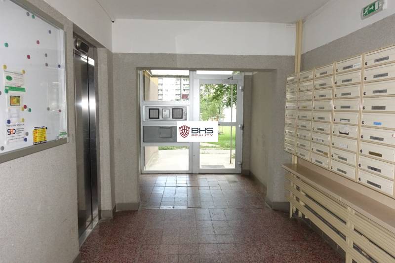 Entrance hall with mailboxes and an elevator in the apartment building.