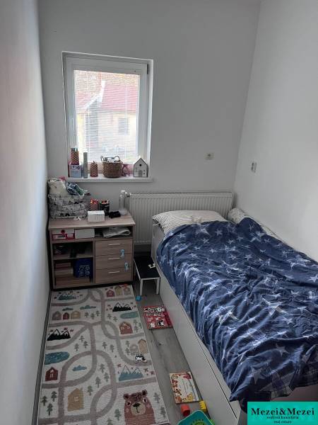 Children's room with a bed, window, and rug in a 4-room apartment.