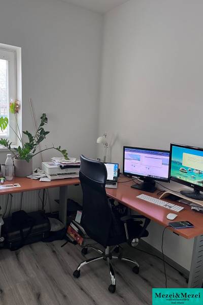 Home office with a computer and wooden decor flooring in a 4-room apartment.