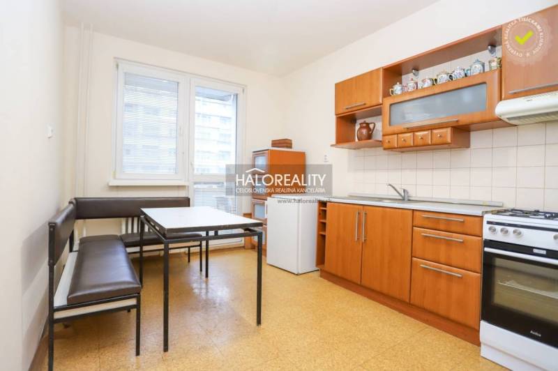 The kitchen in a 3-room apartment with a dining table, kitchen unit, and bright interior.