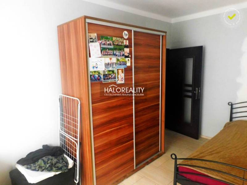 A kitchen with wooden decor and stone cladding in a 2-room apartment.